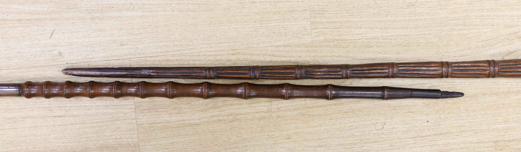 Two carved wood walking sticks, longest 91cms